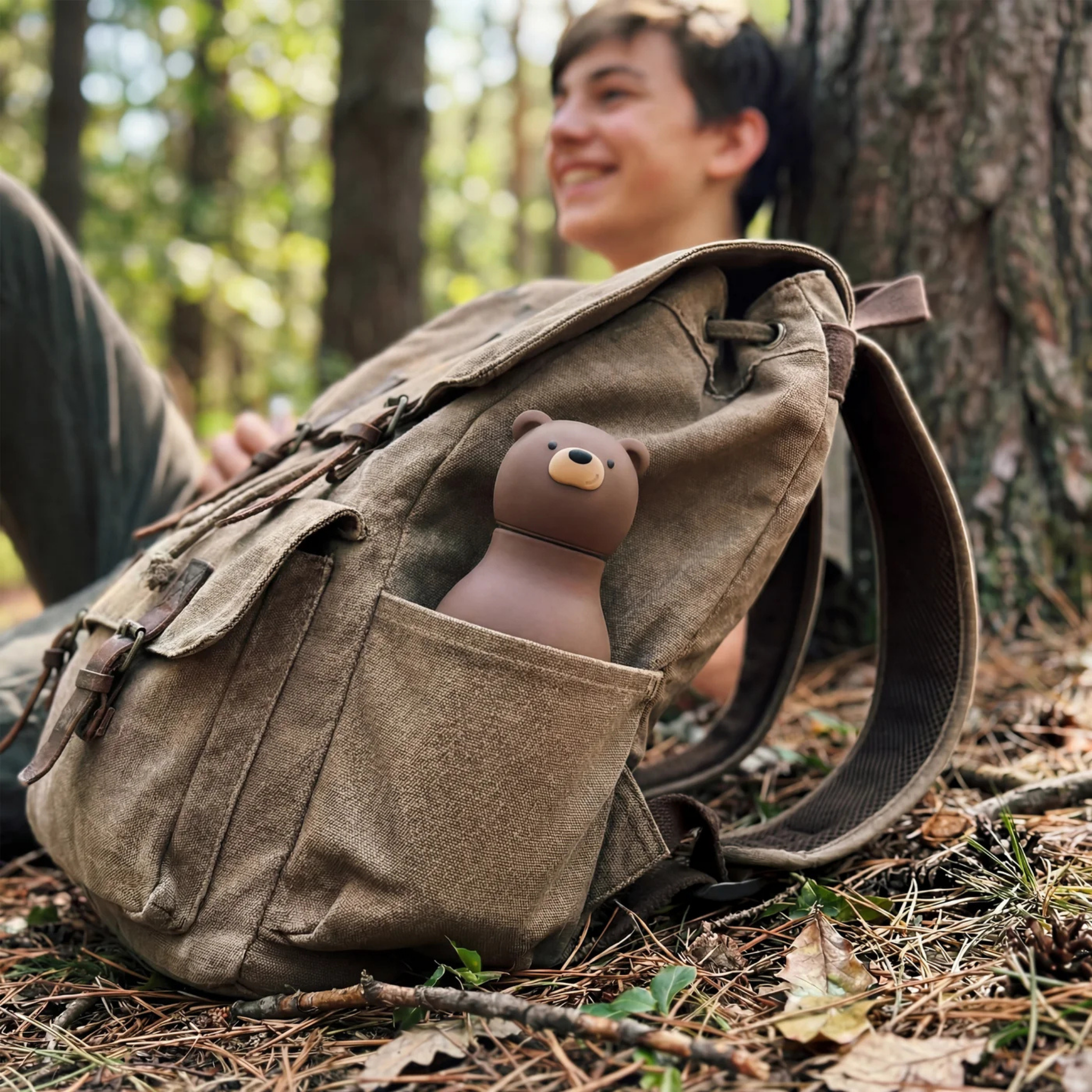 Child carrying Asobu Animal Bestie Bottle in Bear design with removable silicone character head during an everyday adventure in Whistler