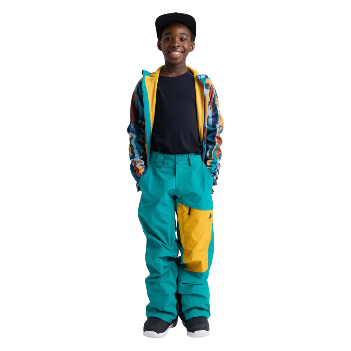 Child wearing Burton Kids GORE-TEX Shell Pants in Pacific Teal / Goldenrod / True Black with waterproof shell protection and boot gaiters while snowboarding in Whistler