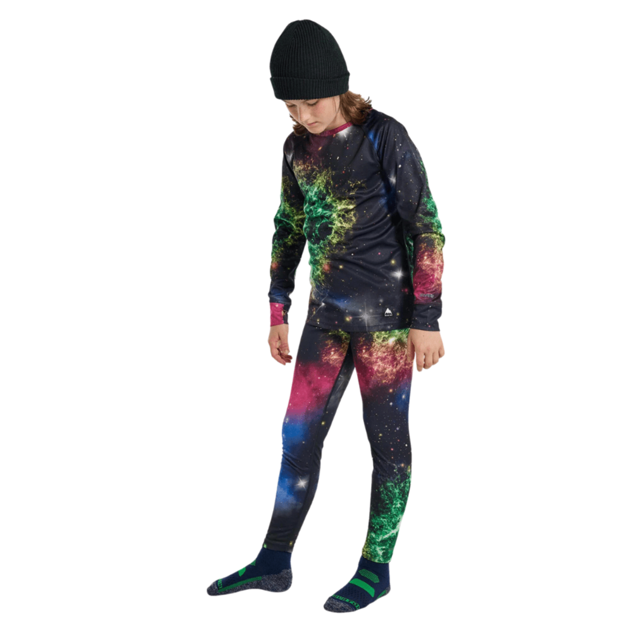 Young skier wearing Burton Kids Lightweight Base Layer Set in Painted Planets design with breathable quick-drying DRYRIDE Ultrawick fabric in Whistler