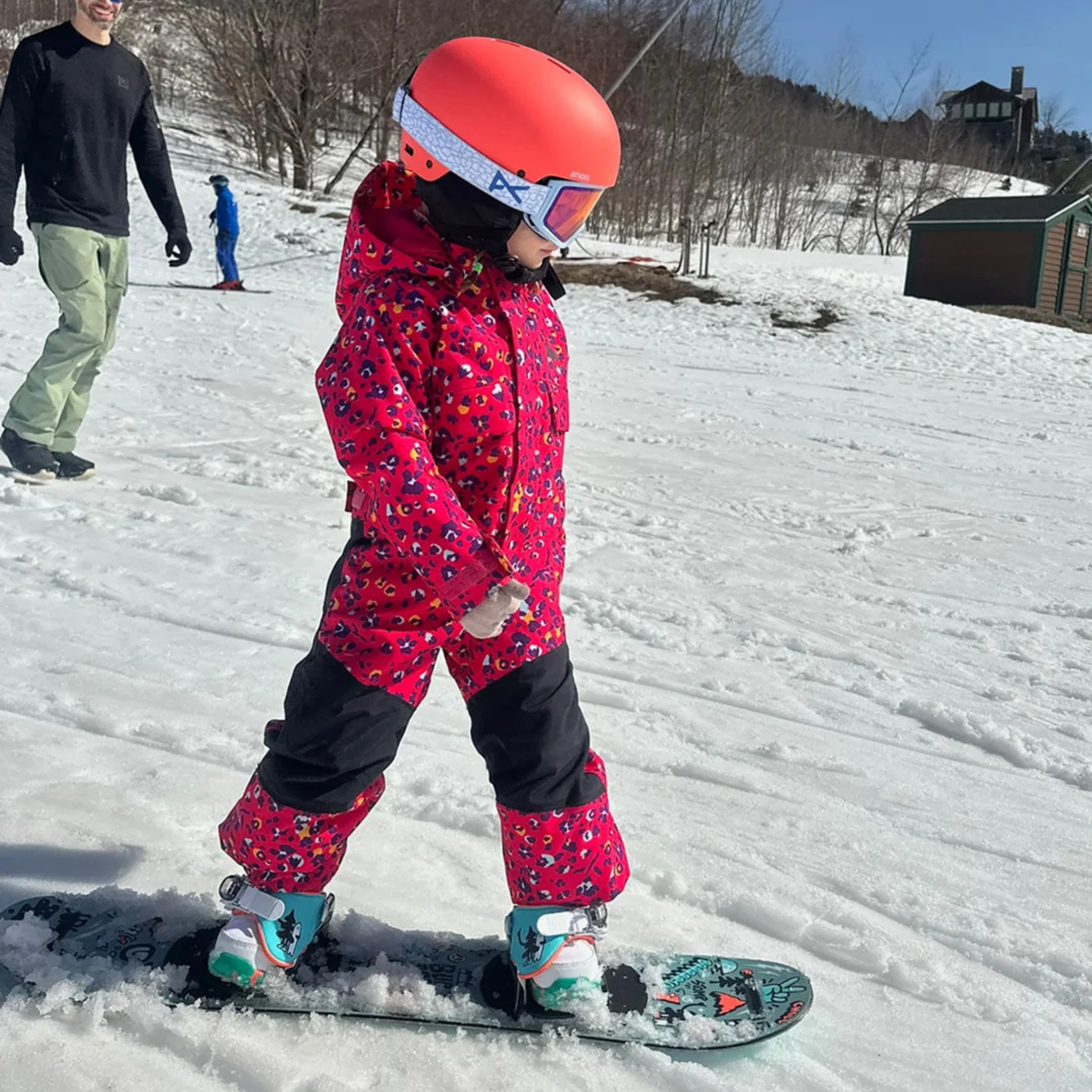 Young rider wearing Burton One-Piece Snowsuit in Wildcat Floral design with 15K waterproofing and 100g insulation in Whistler