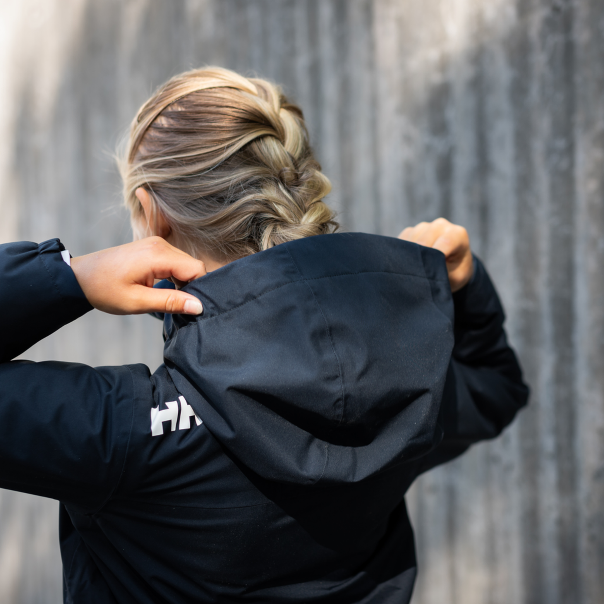 Child wearing Helly Hansen Jr Crew Midlayer 2.0 Unisex Jacket with waterproof protection and fleece lining in Whistler