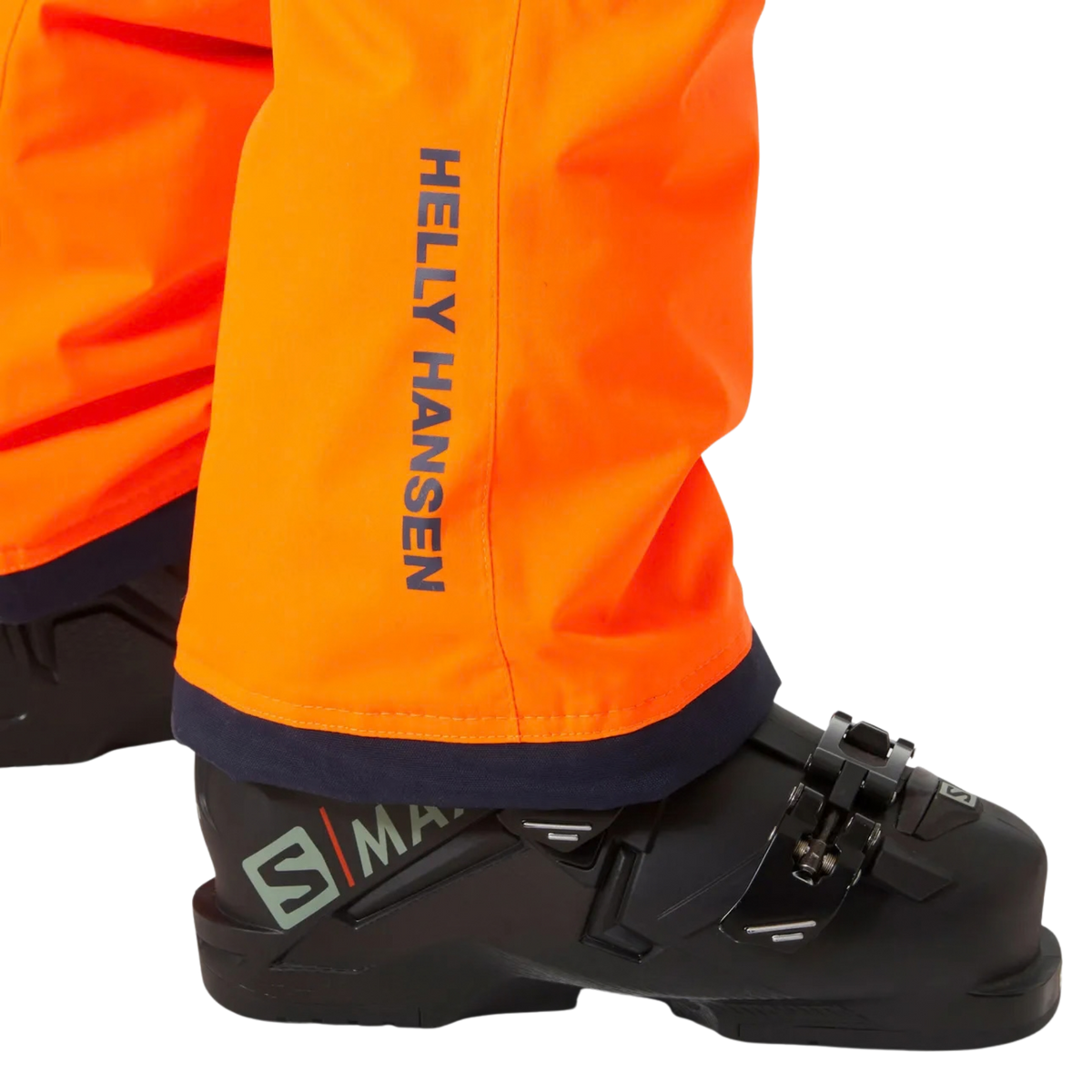Helly Hansen Junior Legendary Pants in Neon Orange with internal boot gaiter and gripper elastic designed to help keep snow out of ski boots