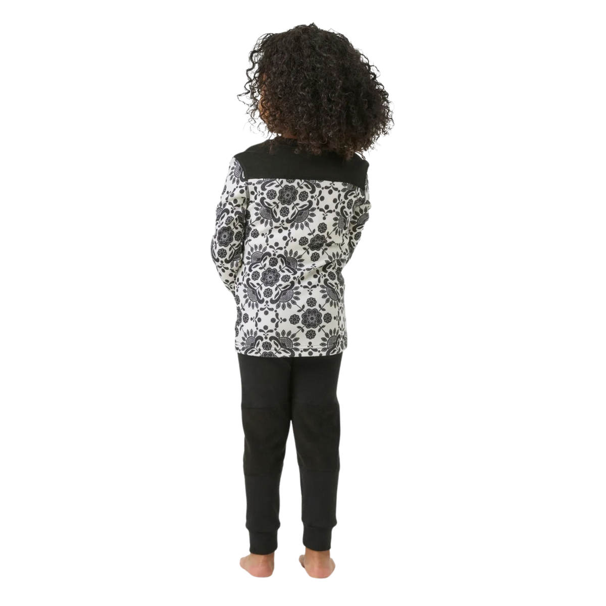 Rear view of Helly Hansen Kids Graphic LIFA Merino Set in Black with flatlock seams and drop-tail top for comfortable winter layering