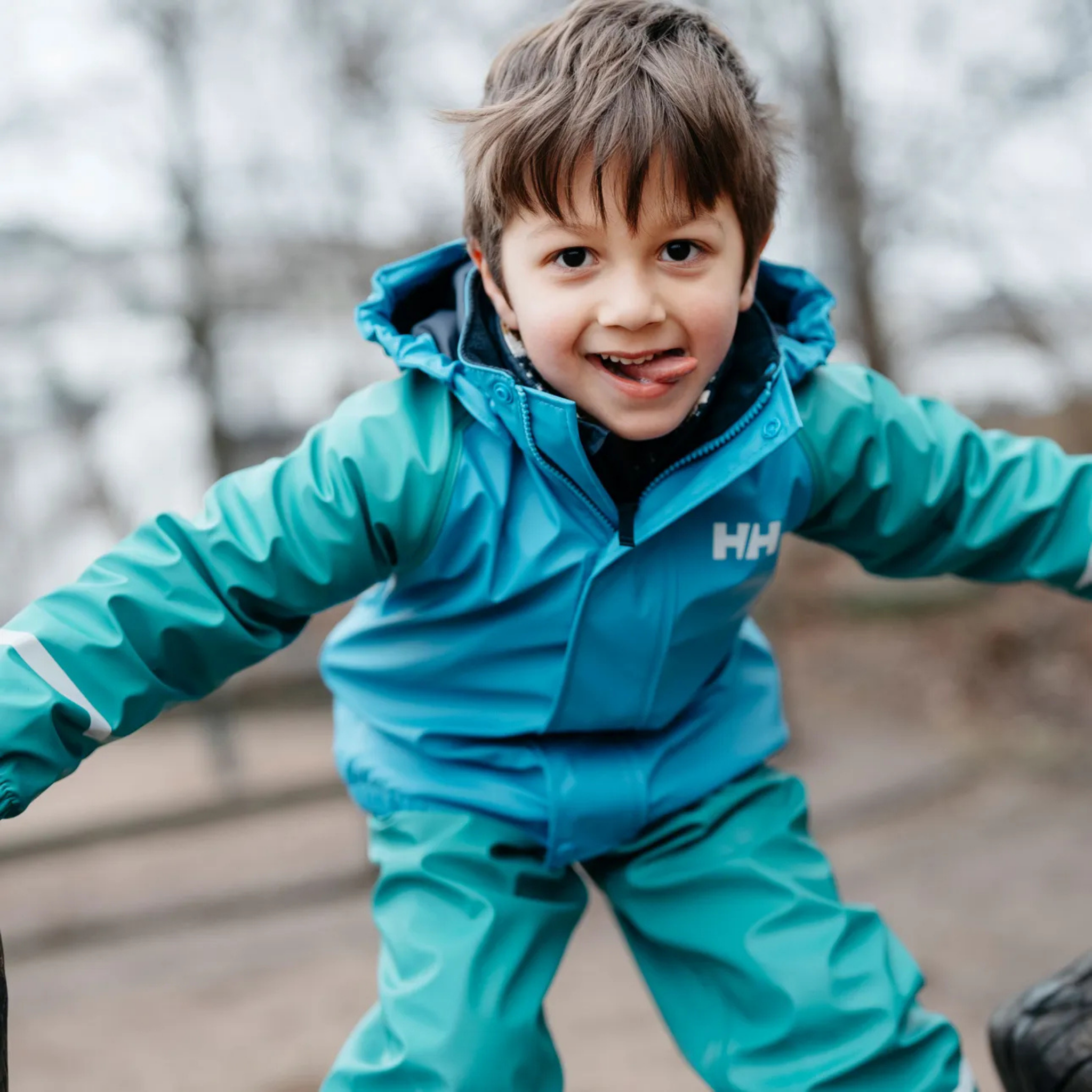 Child wearing Helly Hansen Kids Bergen Fleece-Lined Rain Set 2.0 with waterproof HELOX+ protection and warm fleece lining in Whistler