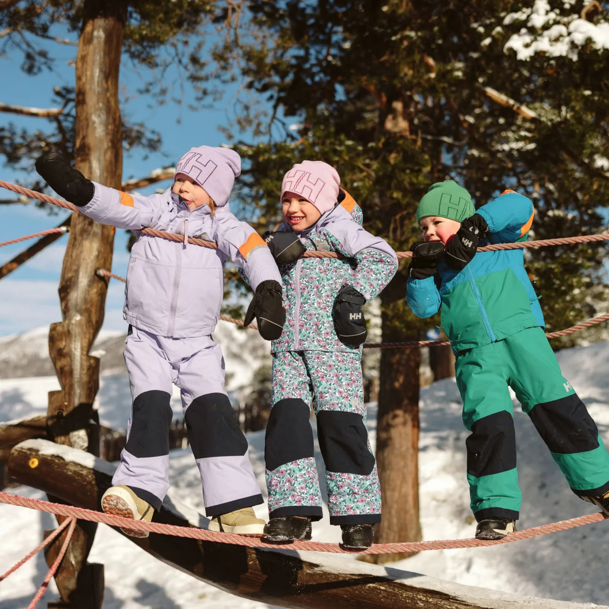 Child wearing Helly Hansen Kids Rider 2.0 Insulated Bib Pants with HELLY TECH protection and PrimaLoft insulation in Whistler snow