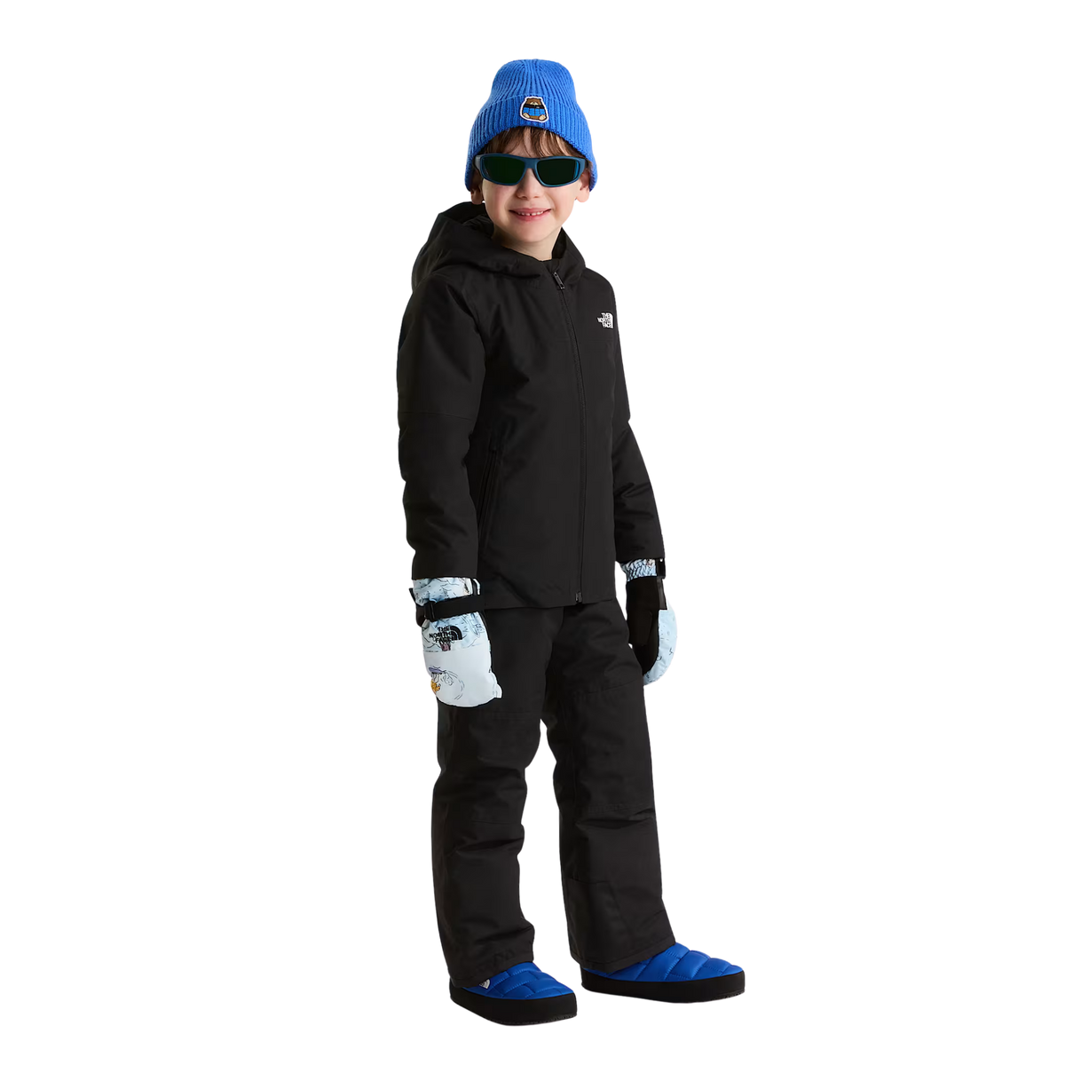 Child wearing North Face Youth ThermoBall Traction Mule II insulated slip-on shoes in Active Blue for cozy après-ski comfort in Whistler
