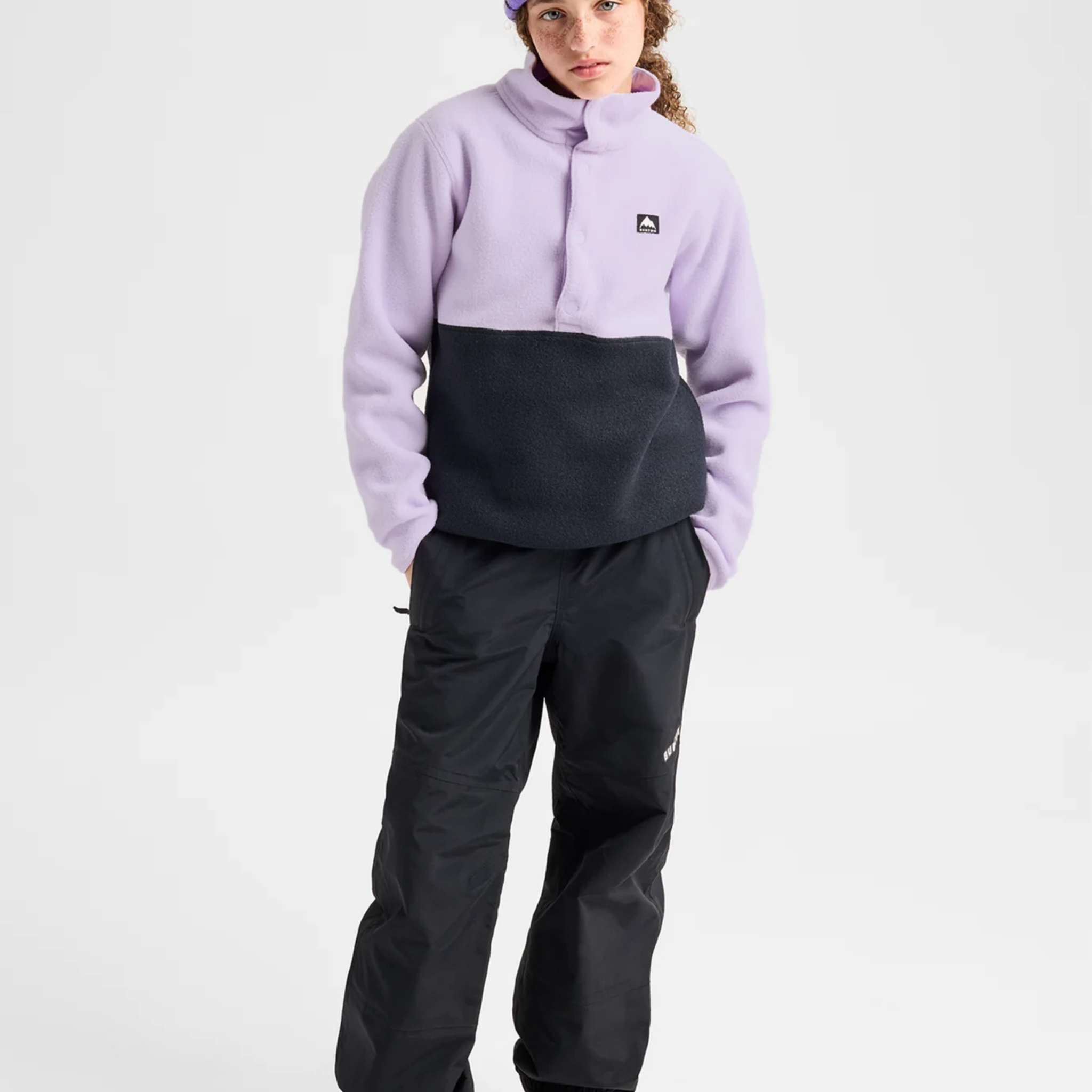 Child wearing Burton Kids' Cinder Fleece Anorak in Moondust Purple and True Black