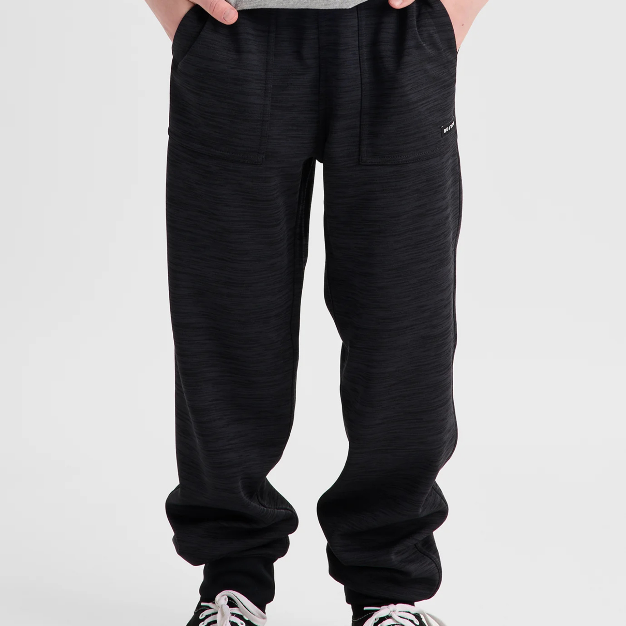 Front view of Burton Kids Oak Fleece Pants in Black Heather with regular fit, drawcord waist and patch-on handwarmer pockets