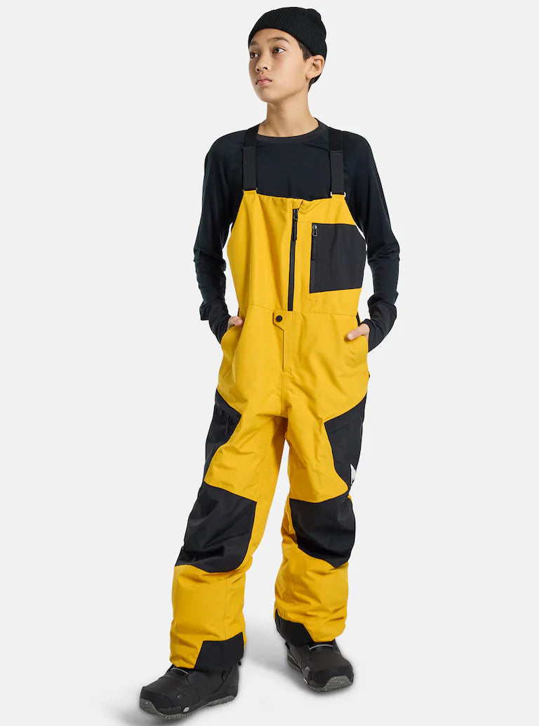 teen boy in yellow and black snow bibs