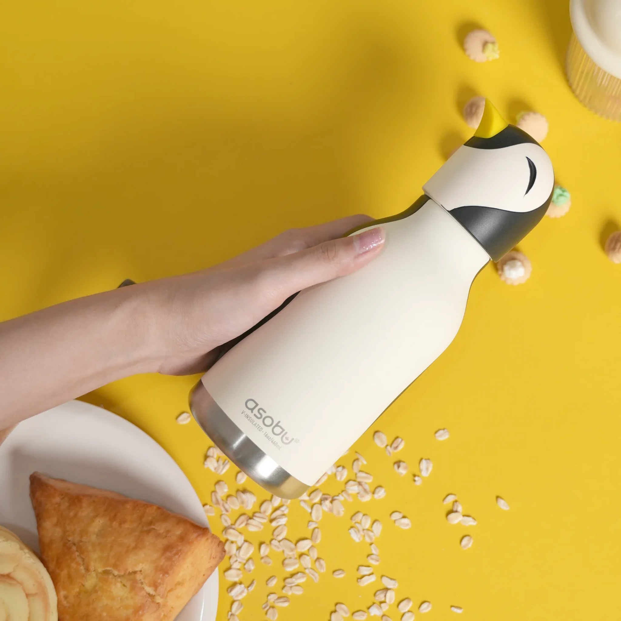 Child carrying Asobu Animal Bestie Bottle in Penguin design with removable silicone character head during an everyday adventure in Whistler