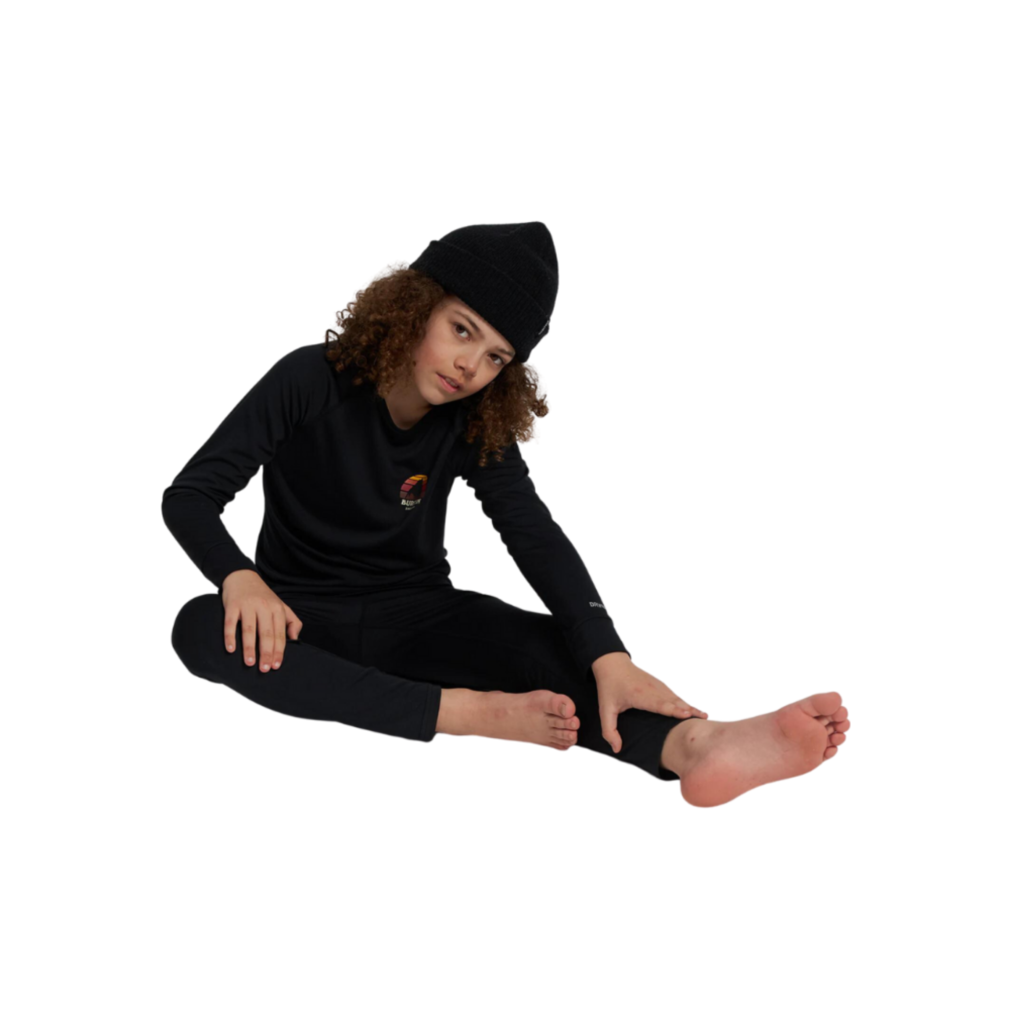 Young skier wearing Burton Kids Lightweight Base Layer Set in True Black design with breathable quick-drying DRYRIDE Ultrawick fabric in Whistler