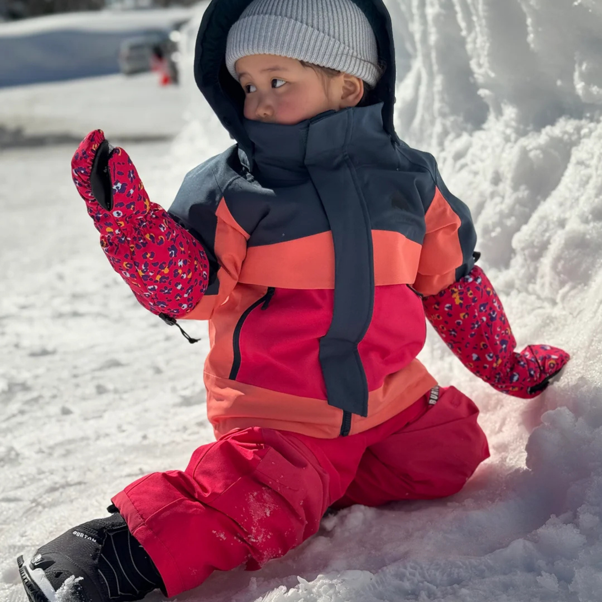 Toddler wearing Burton Ascutney 2L Jacket in Deep Emerald / Peach Echo / Azalea Pink design with 180g insulation and 15K waterproofing on a snowy day in Whistler