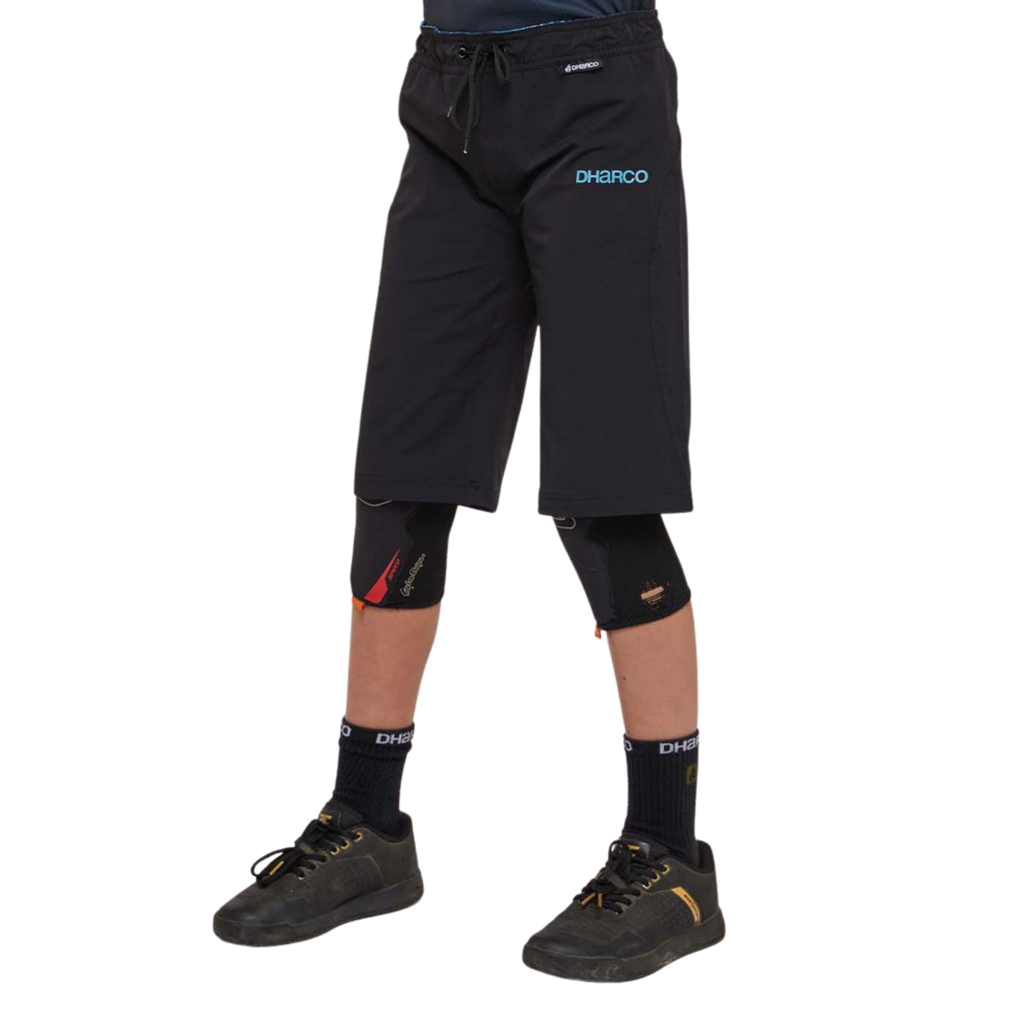 Side view of DHaRCO Youth Gravity Shorts in Black with longer MTB fit, 4-way stretch fabric and zippered pocket
