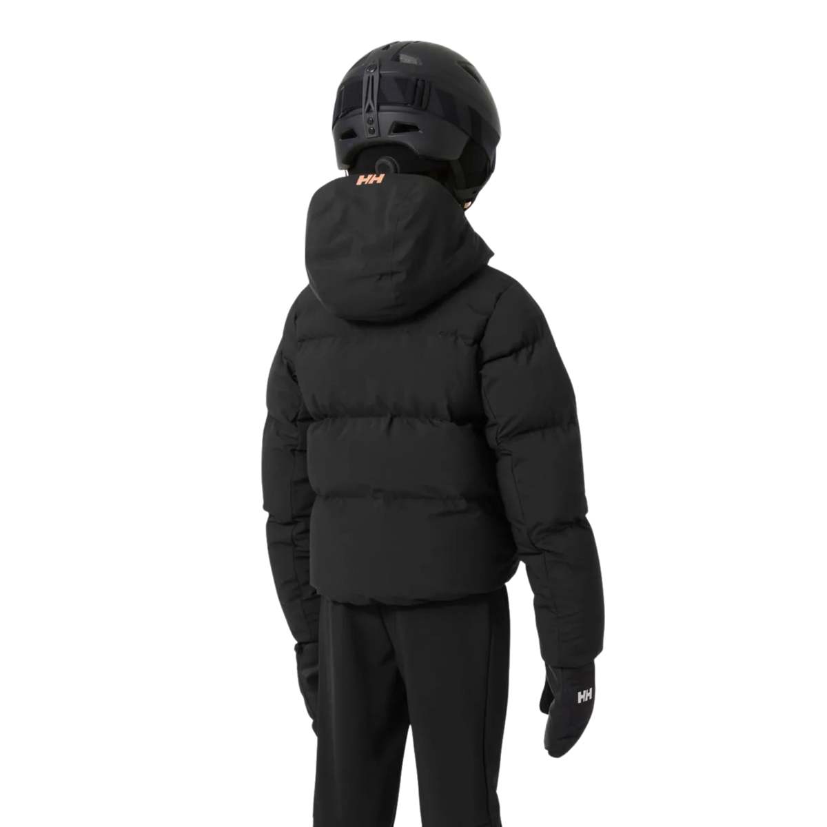 Young skier wearing Helly Hansen Jr Girl Nora Puffy Ski Jacket in Black with synthetic insulation, RECCO reflector and powder skirt in Whistler