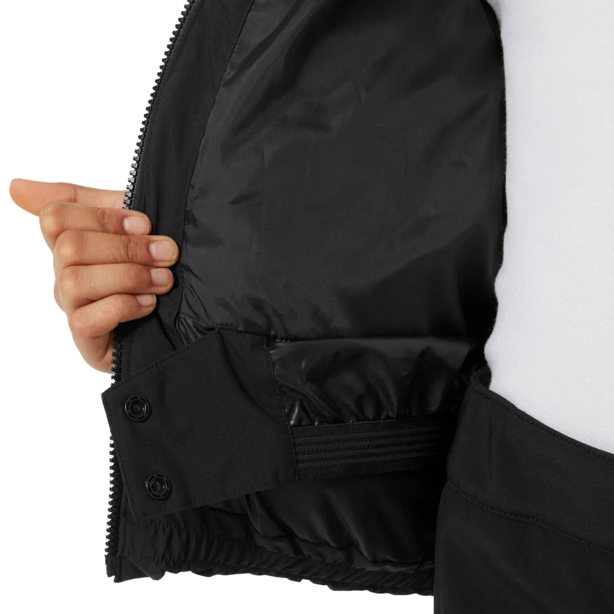 Helly Hansen Jr Girl Nora Puffy Ski Jacket in Black with adjustable internal powder skirt designed to help prevent snow from entering at the waist