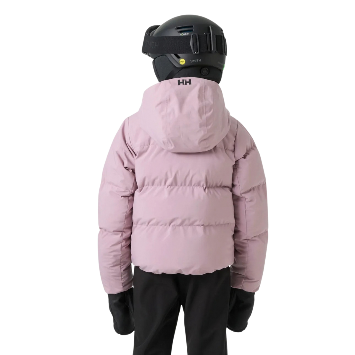 Young skier wearing Helly Hansen Jr Girl Nora Puffy Ski Jacket in Purple Clary with synthetic insulation, RECCO reflector and powder skirt in Whistler