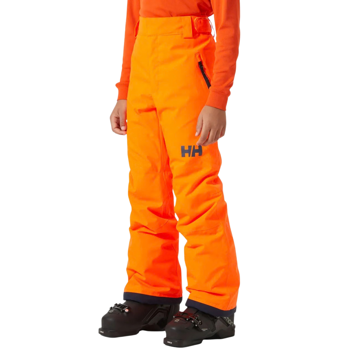 Front view of Helly Hansen Junior Legendary Pants in Neon Orange with waterproof 2-layer shell, adjustable waistband and YKK zippered hand pockets