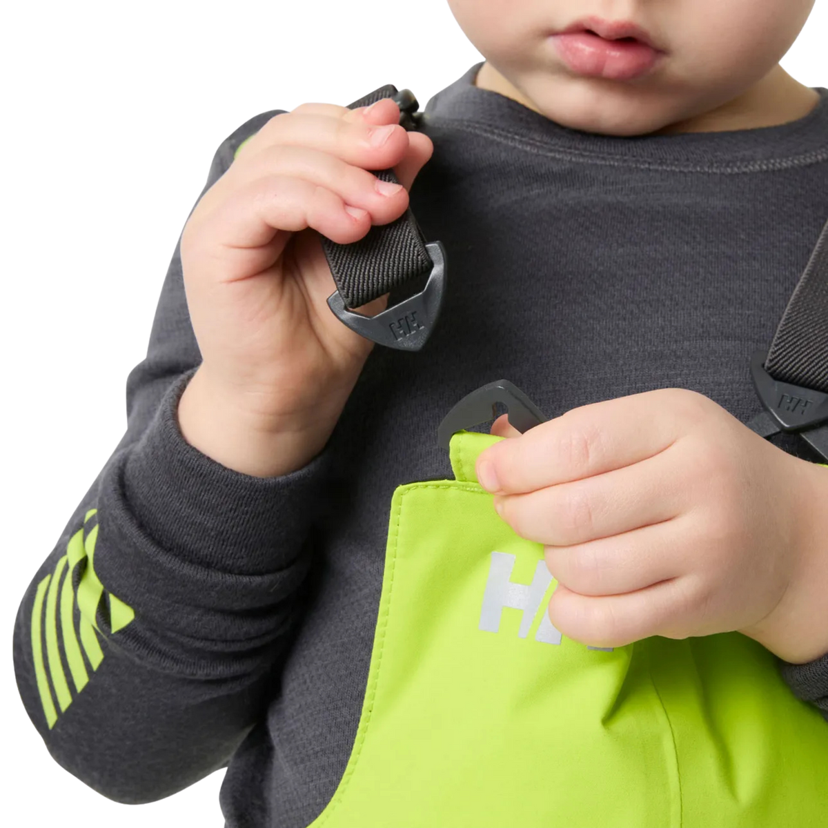 Helly Hansen Kids Rider 2.0 Insulated Bib Pants in Luminous Green with adjustable elastic suspenders for a secure customizable fit