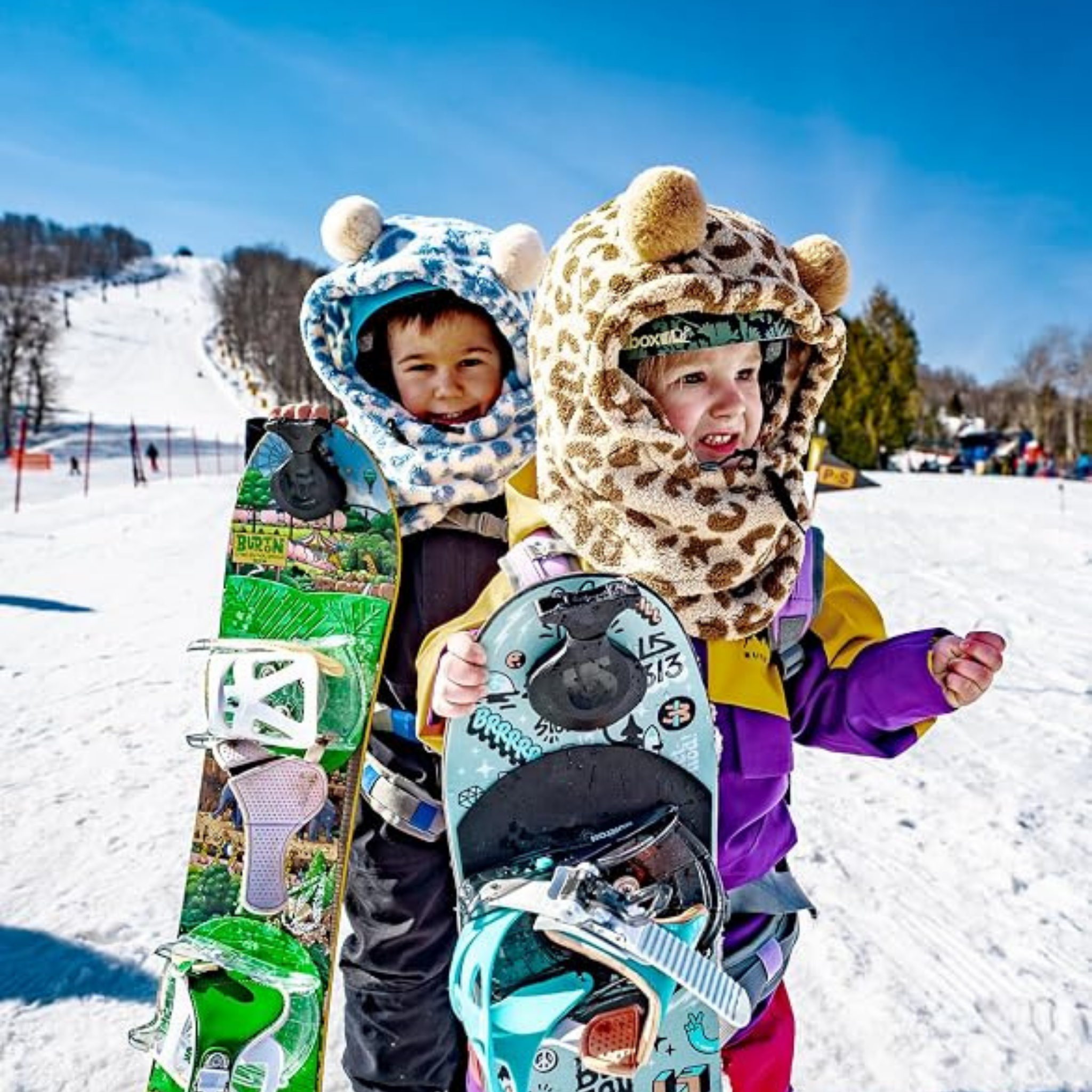 Child wearing MDX One Over the Helmet Balaclava over a ski helmet with plush fleece coverage during a winter day in Whistler