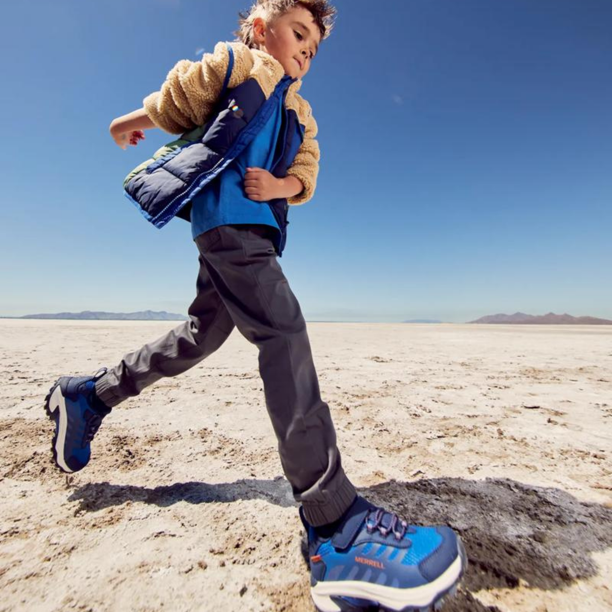 Child wearing Merrell Moab Speed 2 Low A/C Waterproof shoes in Blue / Navy while exploring a wet trail during an outdoor adventure in Whistler