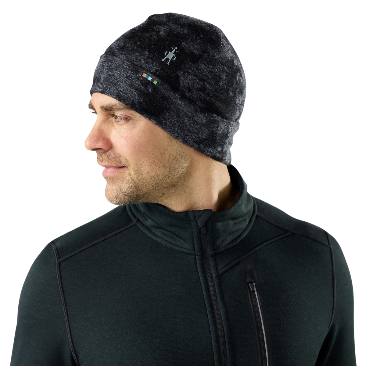 Side view of Smartwool Thermal Merino Reversible Cuffed Beanie in Black Tie Dye with roll cuff providing additional warmth around the ears