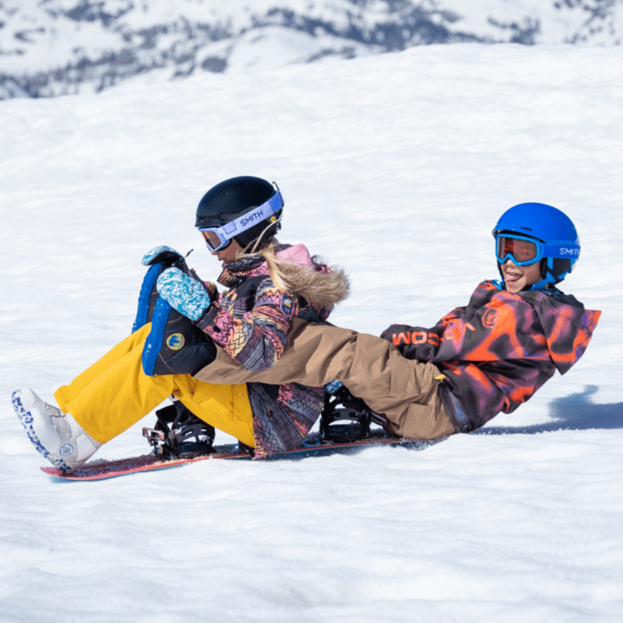Young skier wearing the Smith Glide Jr MIPS Snow Helmet on a snowy mountain