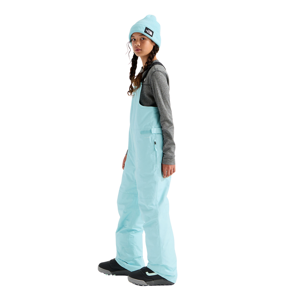 Side view of The North Face Teen Freedom Insulated Bib Pant in Glacier color with insulated construction, adjustable waist and reinforced lower legs