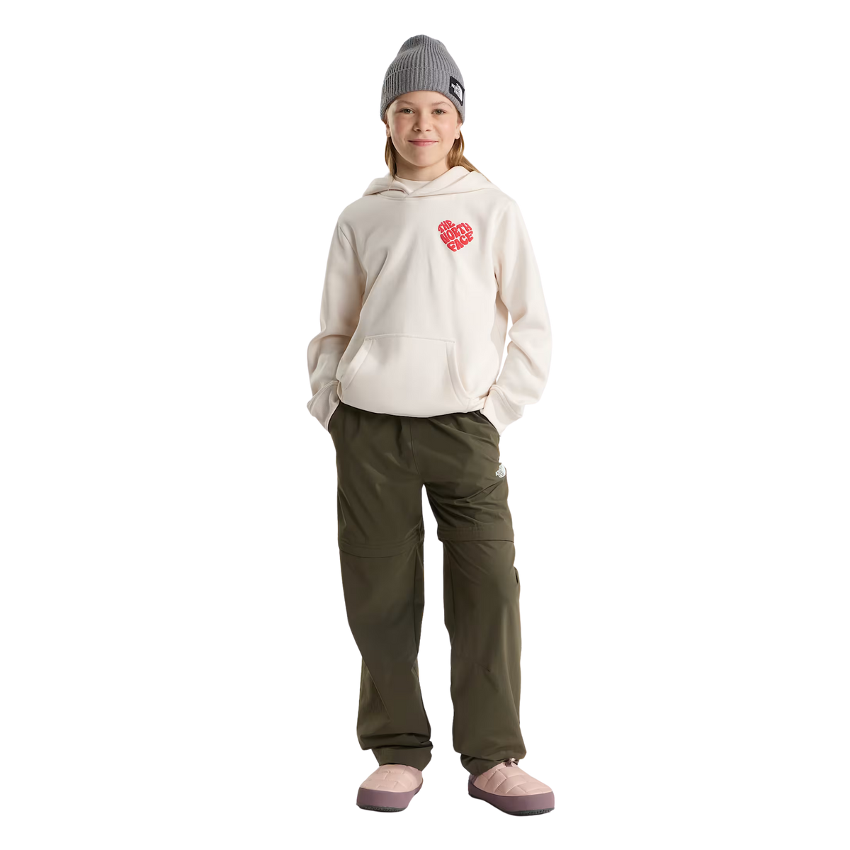 Child wearing North Face Youth ThermoBall Traction Mule II insulated slip-on shoes in Pink Moss for cozy après-ski comfort in Whistler