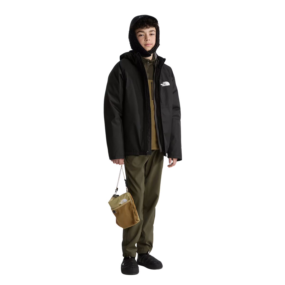 Child wearing North Face Youth ThermoBall Traction Mule II insulated slip-on shoes in TNF Black for cozy après-ski comfort in Whistler