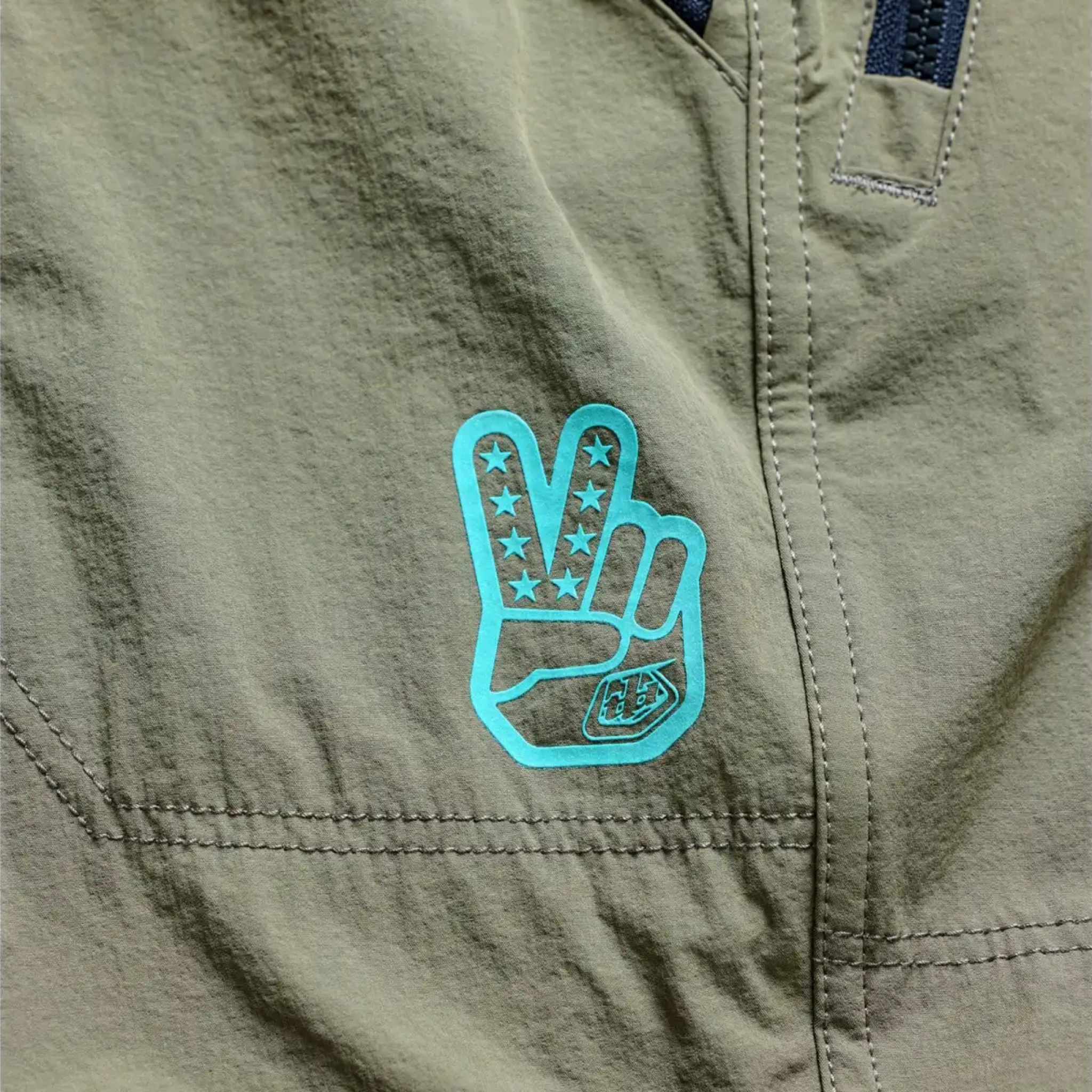 Close-up of reinforced nylon-spandex 4-way stretch fabric on the Troy Lee Skyline Trail Pant showing the logo