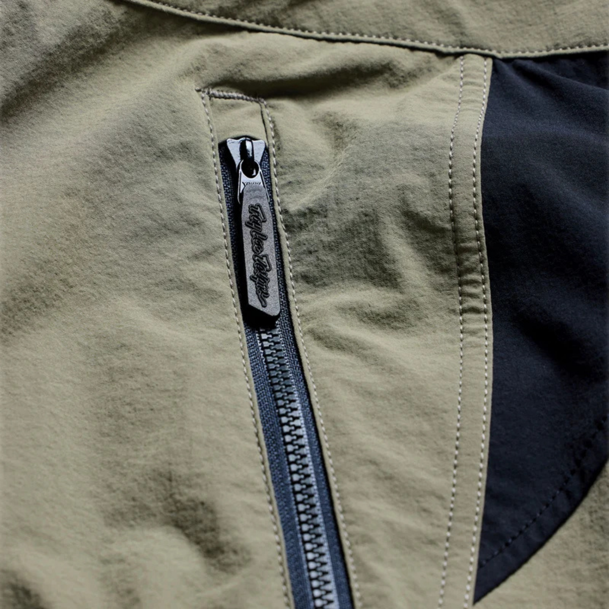 Close-up of Troy Lee Designs Skyline Trail Pant Mono Army with YKK zippered storage pocket