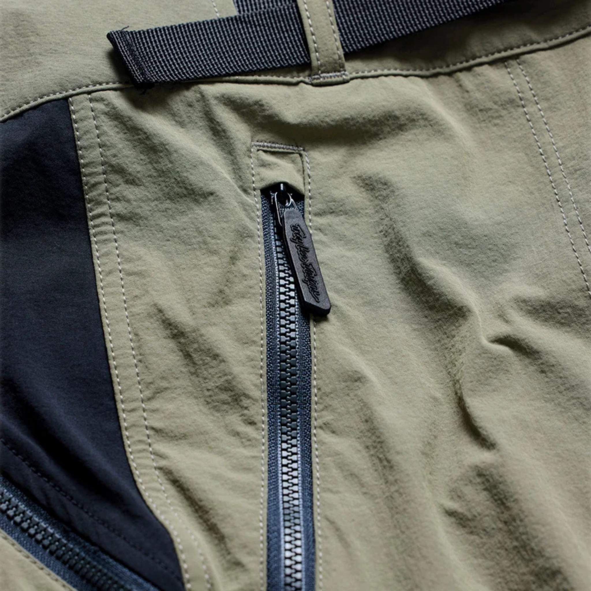 Close-up of Troy Lee Designs Skyline Trail Pant Mono Army with YKK zippered storage pocket