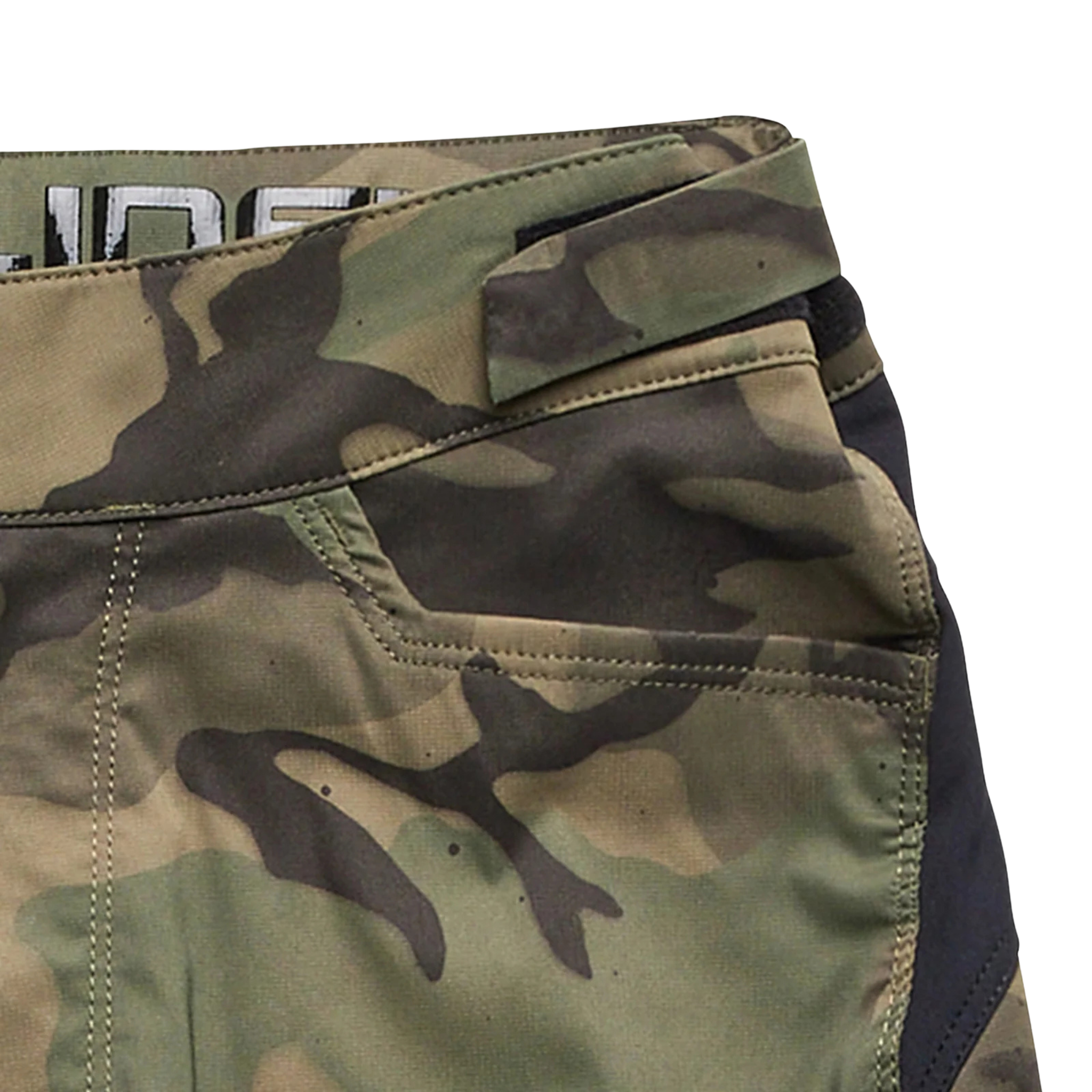 Close-up of the adjustable waistband and silicone grip on Troy Lee Designs Youth Flowline Short Shell in Spray Camo