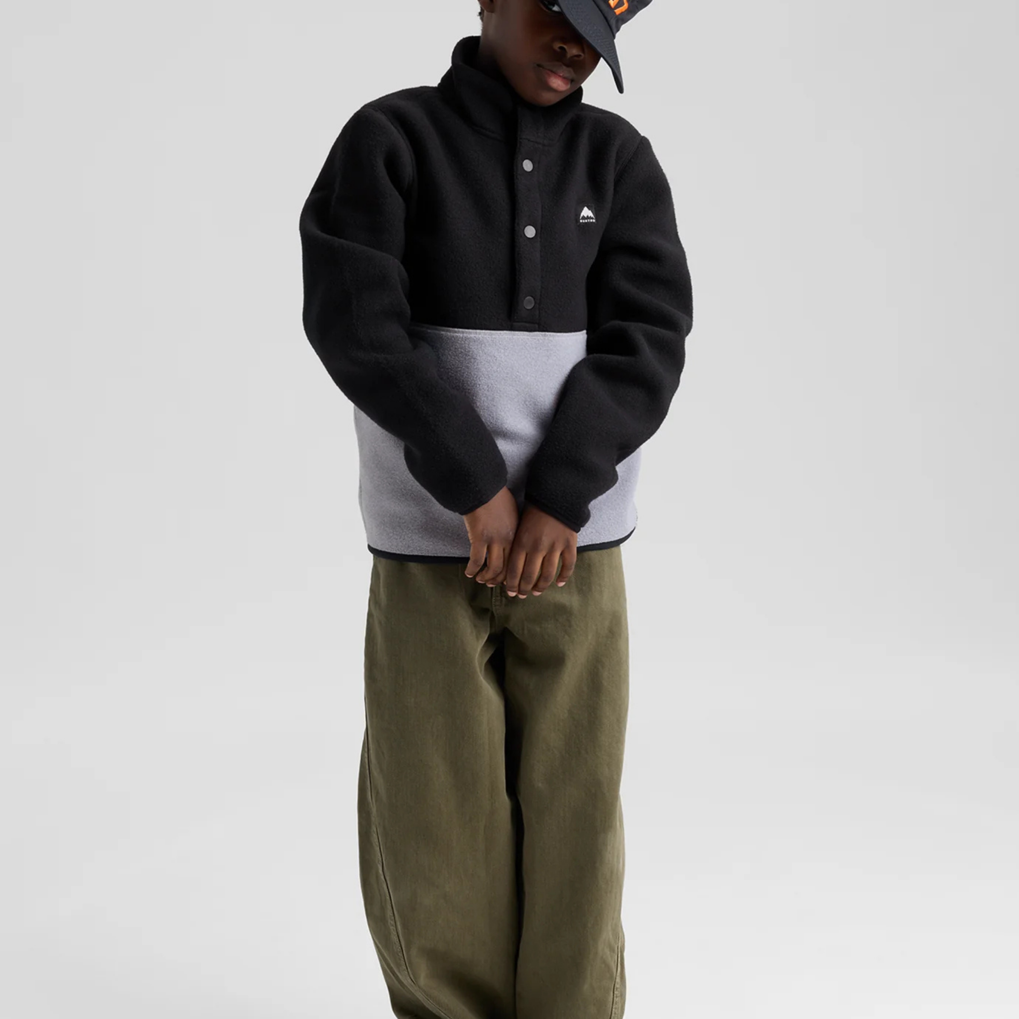 Child wearing Burton Kids Cinder Fleece Anorak in True Black and Grey Heather for comfortable everyday outdoor wear