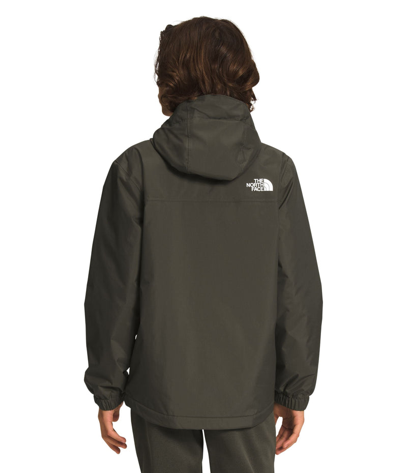 Back of a Boy wearing green North Face Boys' Warm Storm Jacket from Mountain Kids Outfitters, ready for cold and rainy weather.