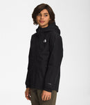 Side of a Boy wearing black North Face Boys' Warm Storm Jacket from Mountain Kids Outfitters, ready for cold and rainy weather.