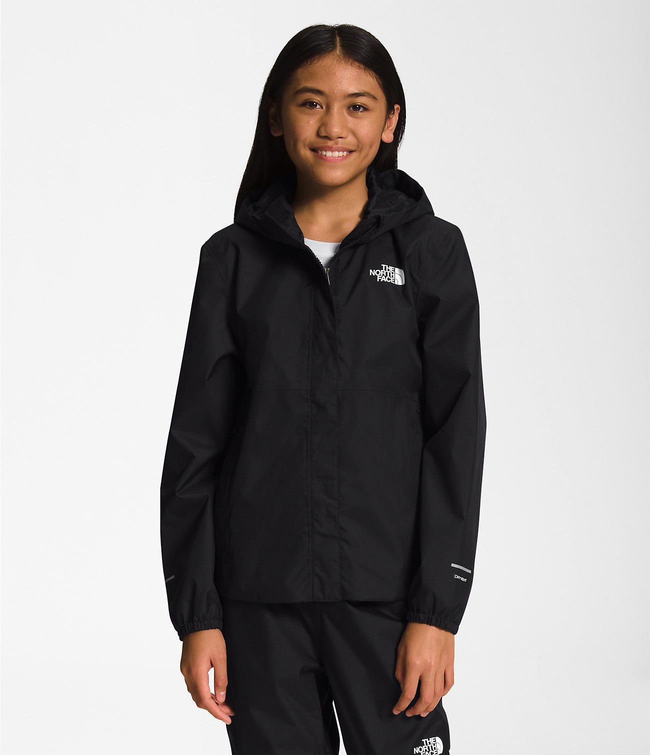 Smiling girl wearing Black The North Face Girls' Warm Storm Jacket - Mountain Kids Outfitters: Stylish and Weather-Ready Outerwear