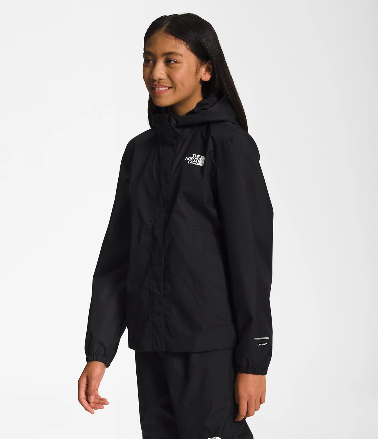 Side View of a Smiling girl wearing Black The North Face Girls' Warm Storm Jacket - Mountain Kids Outfitters: Stylish and Weather-Ready Outerwear