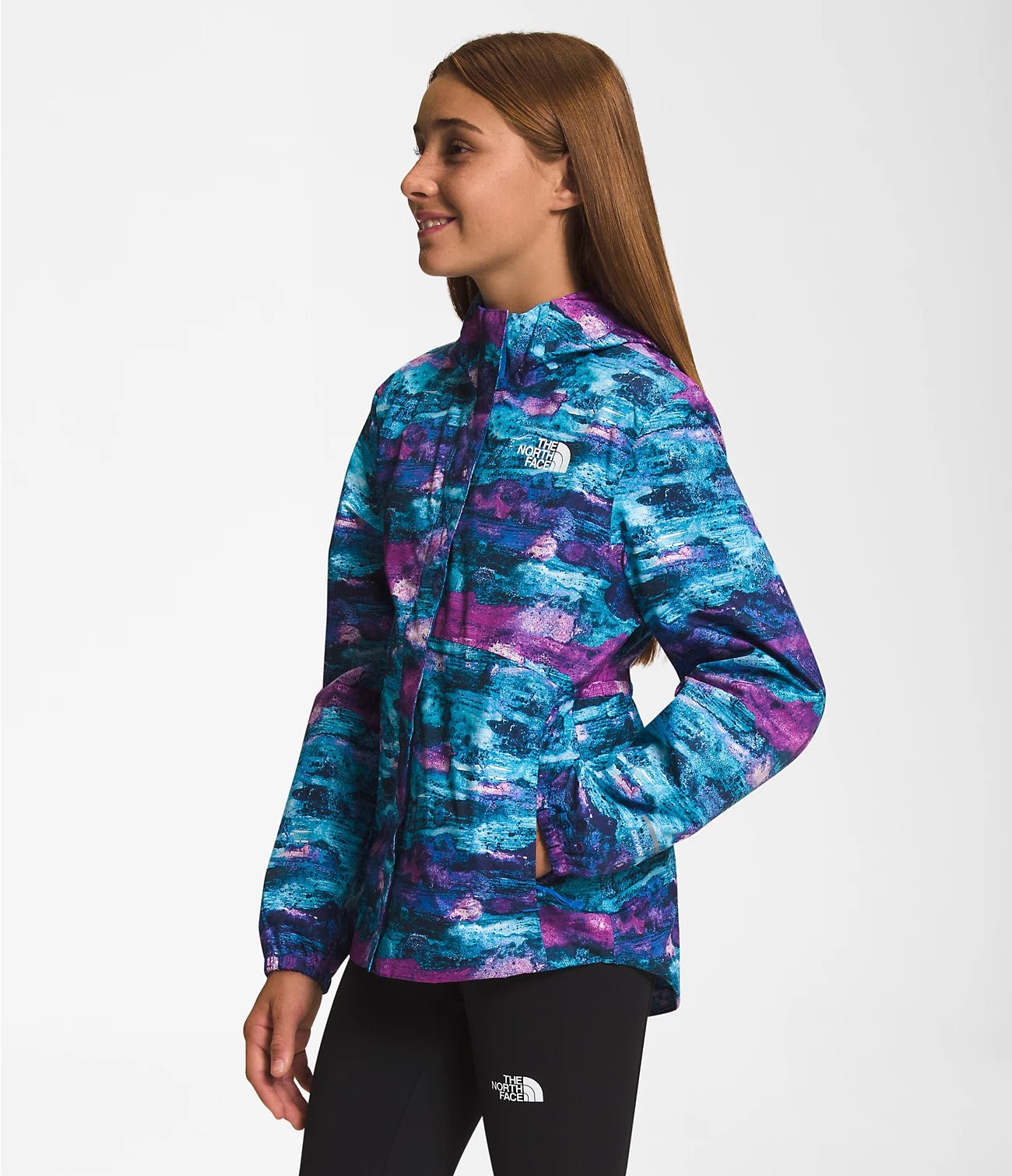 Side view of a Smiling girl wearing Purple Cactus Flower The North Face Girls' Warm Storm Jacket - Mountain Kids Outfitters: Stylish and Weather-Ready Outerwear