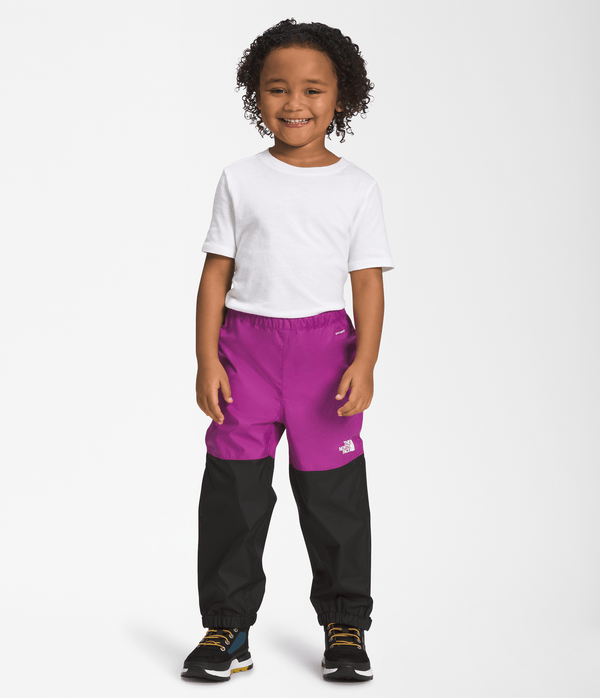 The North Face Kids Antora Rain Pants in Purple Cactus Flower - Smiling kid with a full front view of the rain pants.