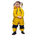 Smiling little girl wearing Yellow Tuffo Muddy Buddy Mountain Kids Canada rain suit against a white background.