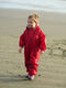 Little girl walking in the sand wearing Red Tuffo Muddy Buddy Mountain Kids Canada rain suit. 