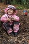 Kid covered in mud while wearing Tuffo Muddy Buddy rain suit in a mountain environment.